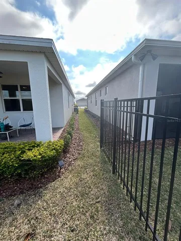 a view of house with patio outdoor seating and plants