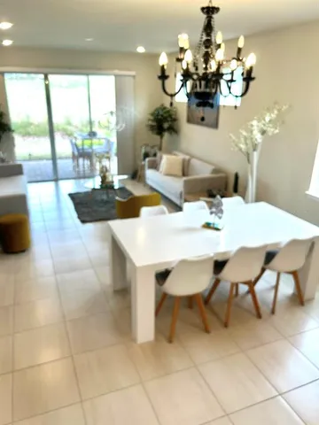 a view of a dining room with furniture wooden floor and chandelier