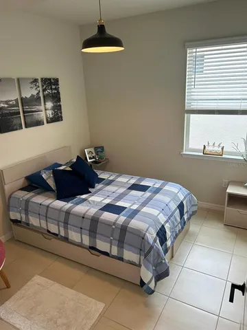 a bedroom with a bed and lamp