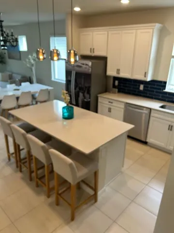 a kitchen with a sink a stove and chairs