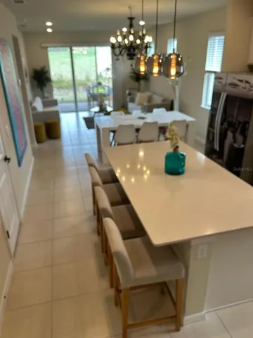 a view of a dining room with furniture wooden floor and chandelier