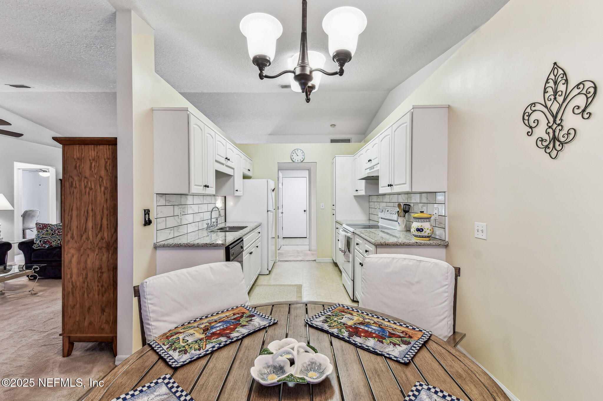 117 Gator Trail Melrose, FL 32666 - Photo 17 of 67 a living room with lots of white furniture and a chandelier