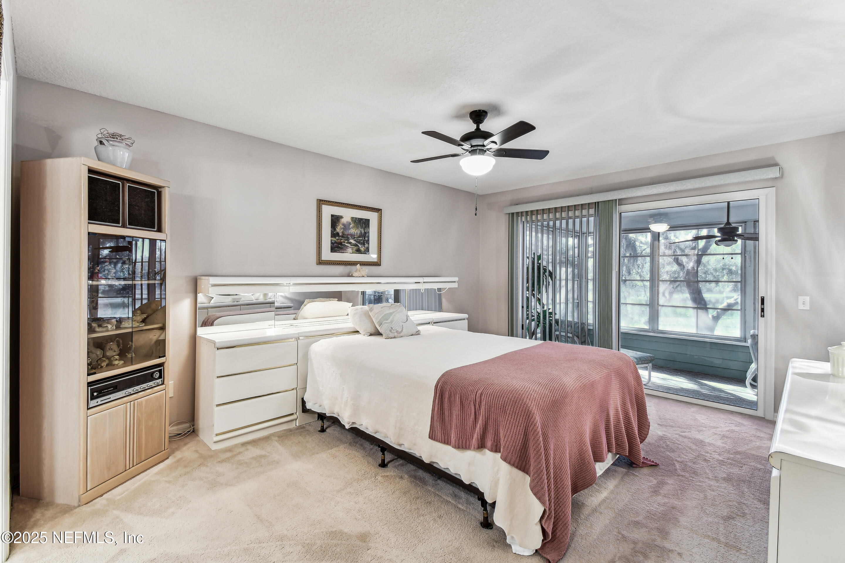 117 Gator Trail Melrose, FL 32666 - Photo 22 of 67 a spacious bedroom with a large bed and a chandelier