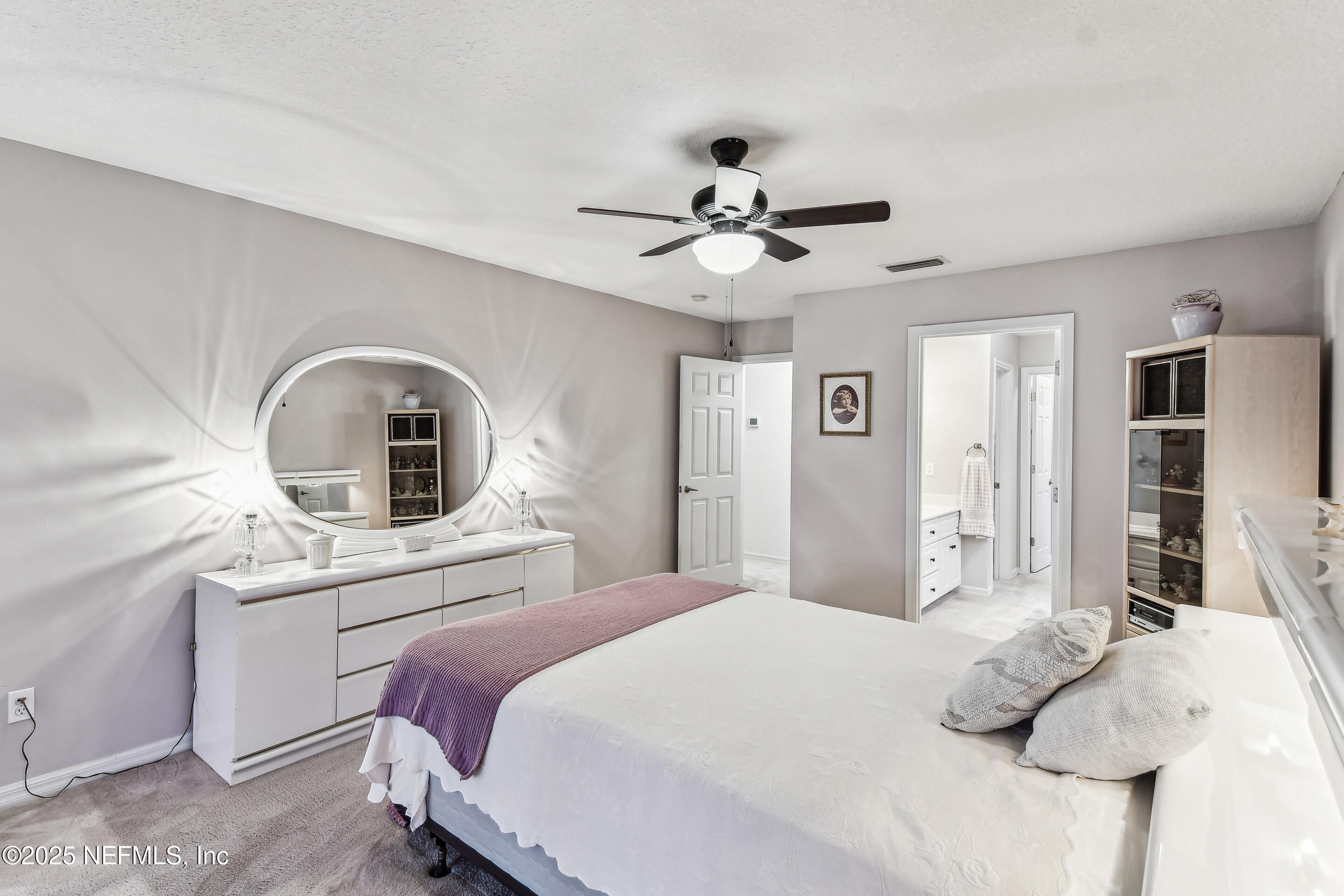 117 Gator Trail Melrose, FL 32666 - Photo 24 of 67 a bedroom with a bed and a chandelier