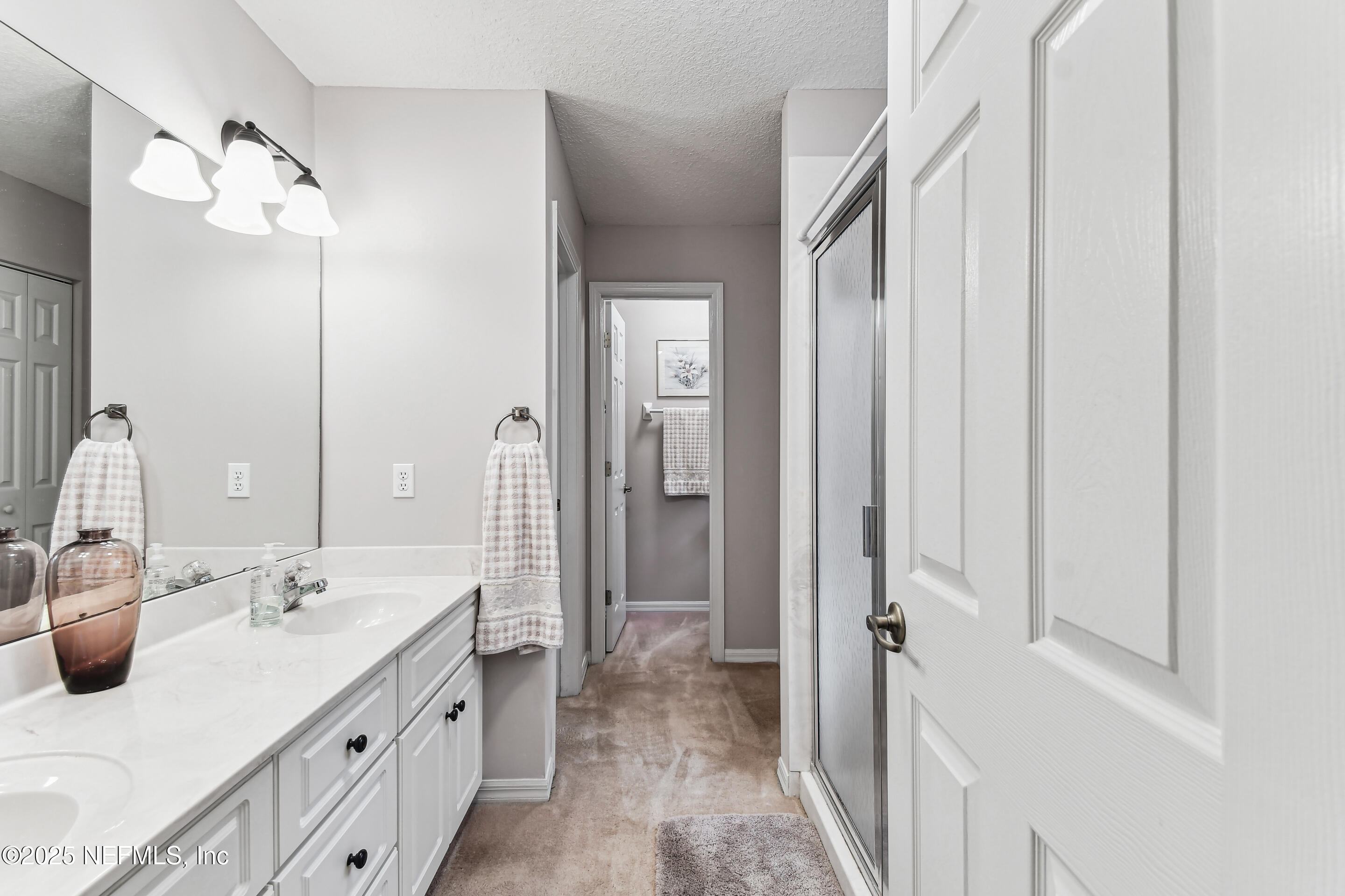 117 Gator Trail Melrose, FL 32666 - Photo 26 of 67 a spacious bathroom with a double vanity sink and mirror