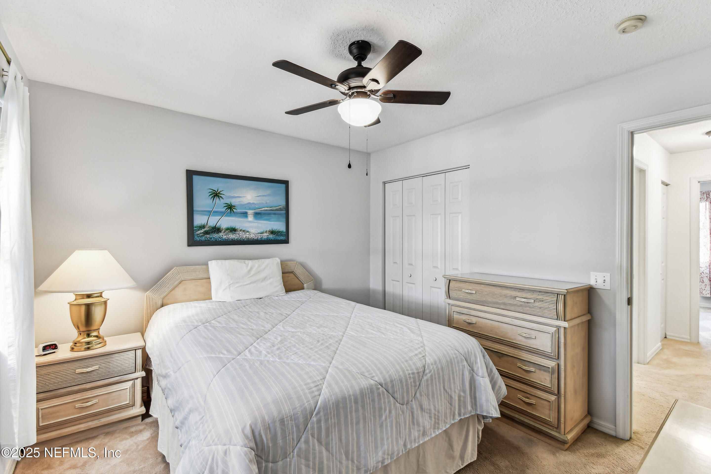 117 Gator Trail Melrose, FL 32666 - Photo 29 of 67 a bedroom with a bed and a chandelier