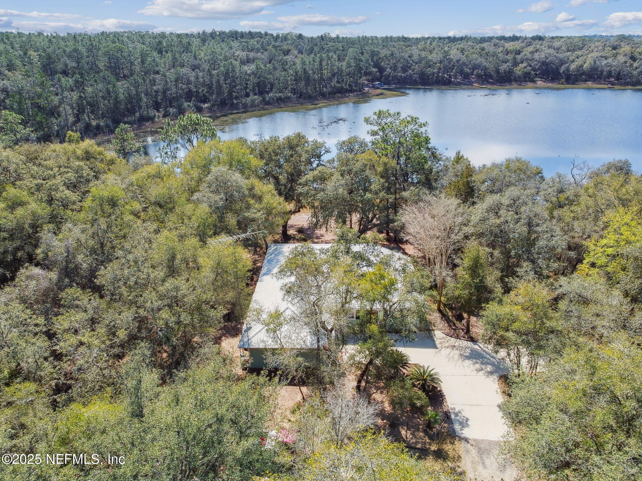 117 Gator Trail Melrose, FL 32666 - Photo 54 of 67 a view of a lake with trees in the background