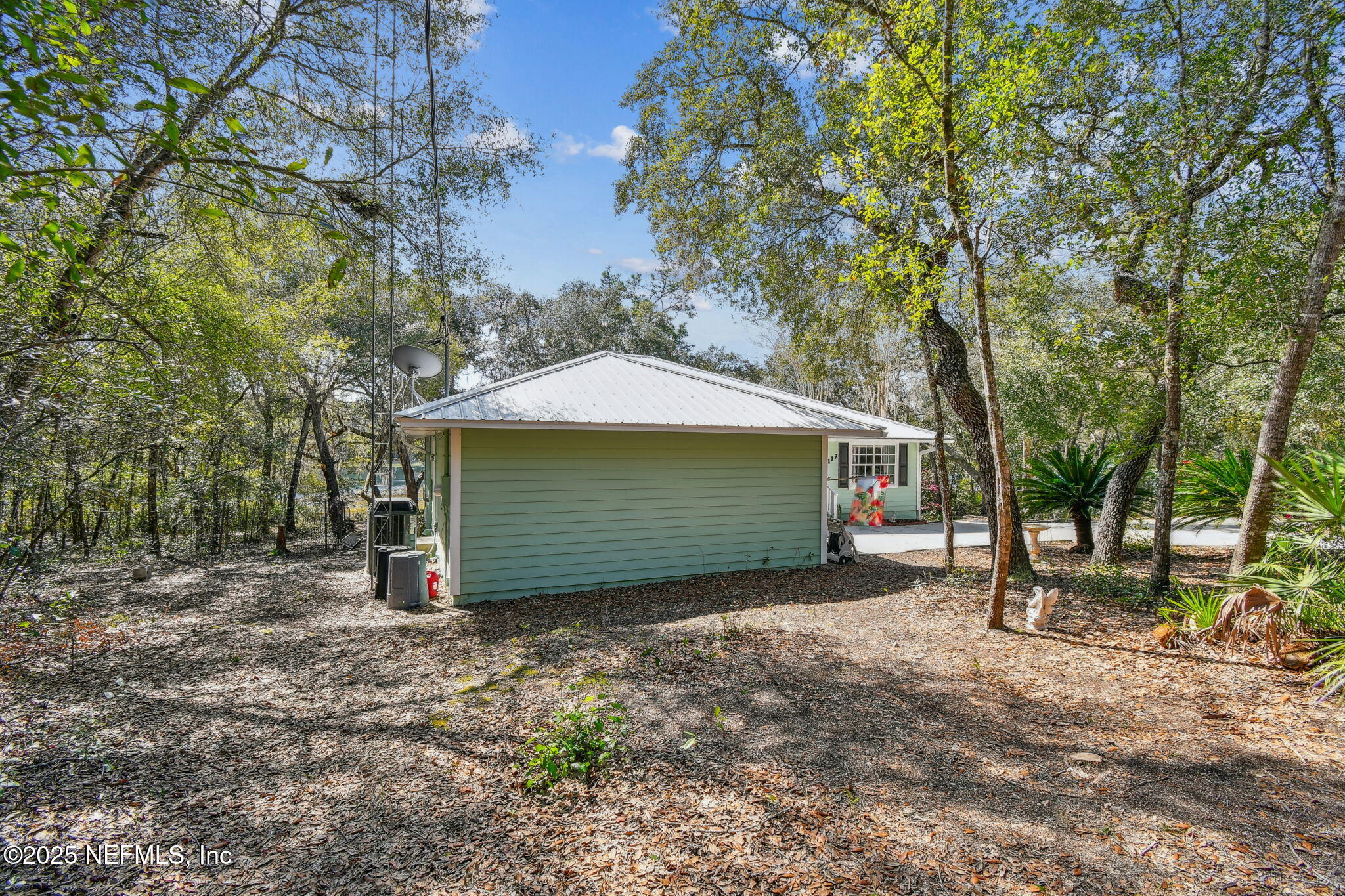 117 Gator Trail Melrose, FL 32666 - Photo 56 of 67 a view of a house with large trees and wooden fence