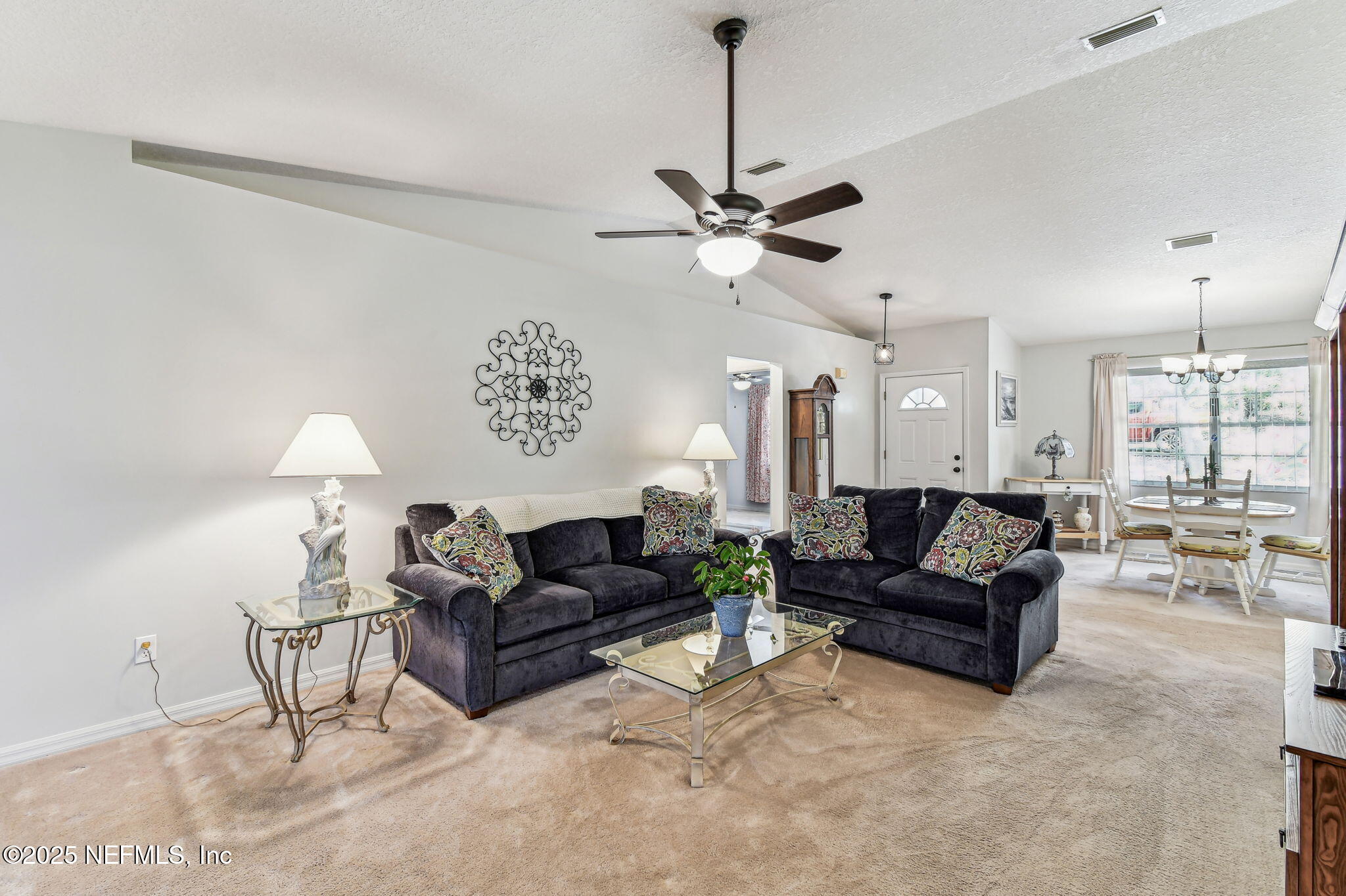 117 Gator Trail Melrose, FL 32666 - Photo 6 of 67 a living room with furniture and a chandelier
