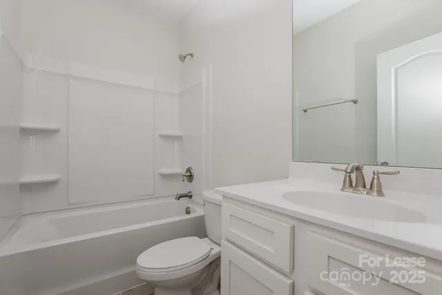 a bathroom with a sink toilet vanity and bathtub