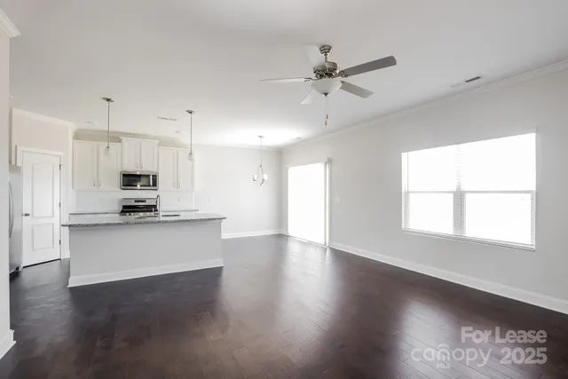 a view of kitchen with sink and refrigerator