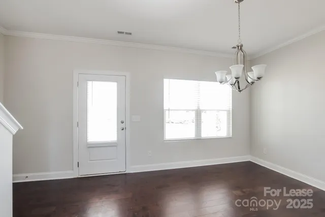 a view of a room with wooden floor and windows
