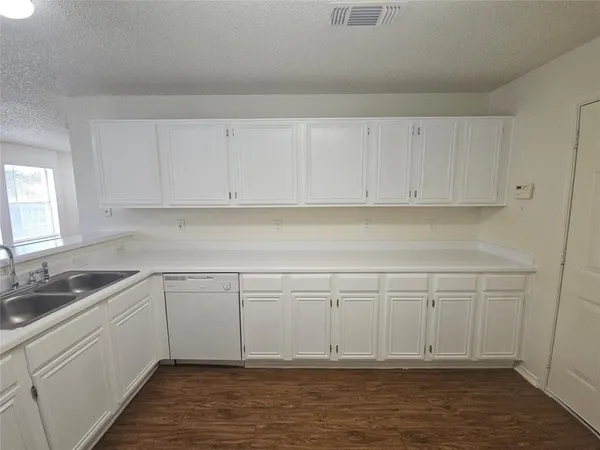 a kitchen with white cabinets