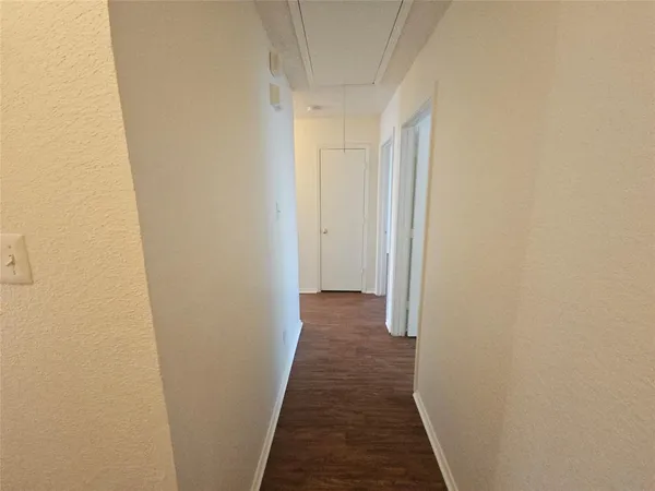 a view of a hallway with a wooden floor