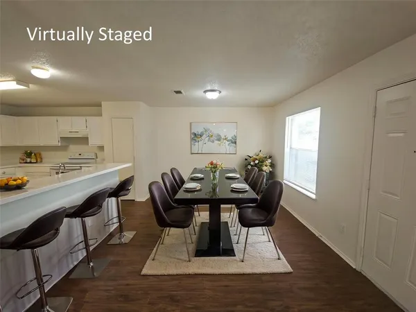 a dining room with furniture and window