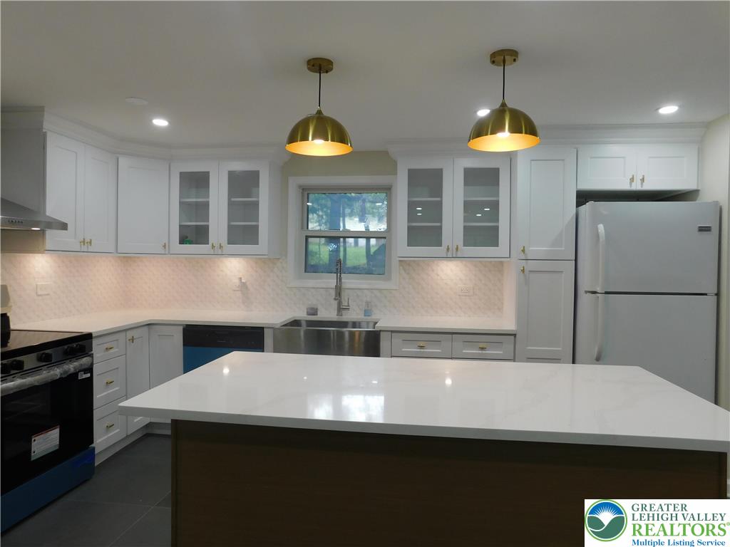 1405 Donalds Road Effort, PA 18330 - Photo 7 of 31 a kitchen with stainless steel appliances a sink a stove a refrigerator and cabinets