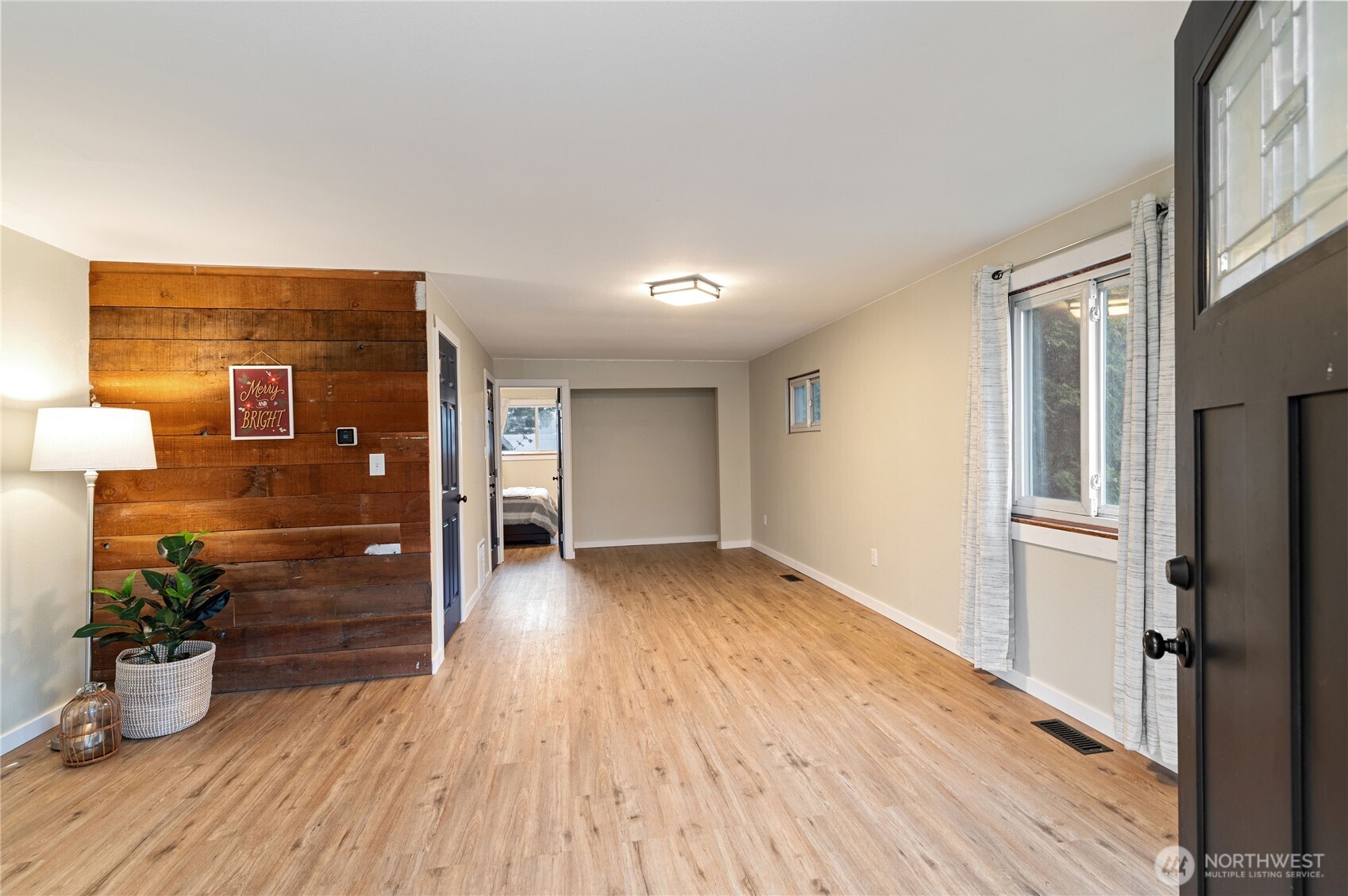 2013 8th Street Bremerton, WA 98337 - Photo 6 of 22 a view of a hallway with wooden floor and a potted plant