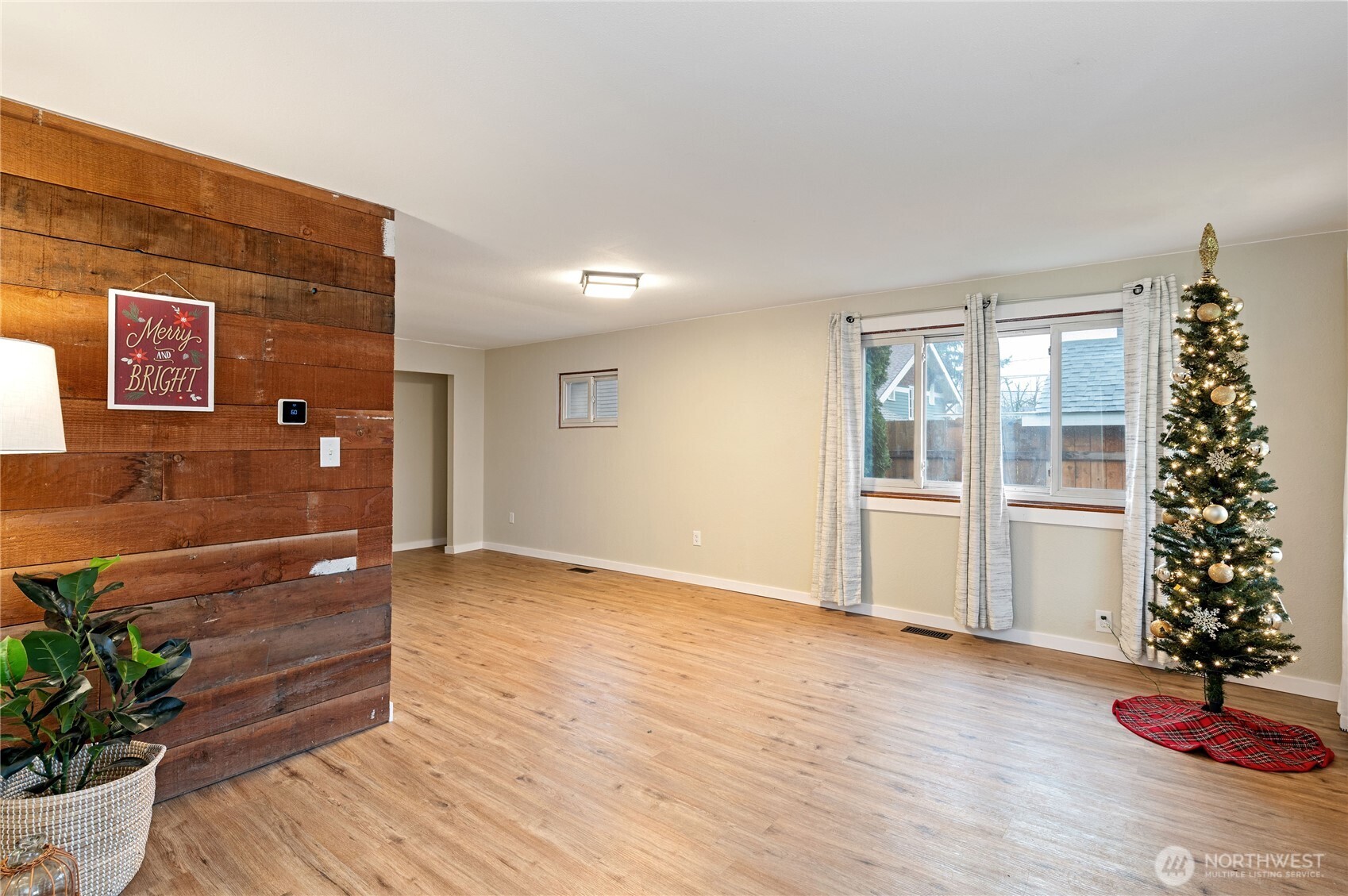 2013 8th Street Bremerton, WA 98337 - Photo 7 of 22 a view of an empty room with wooden floor and a window