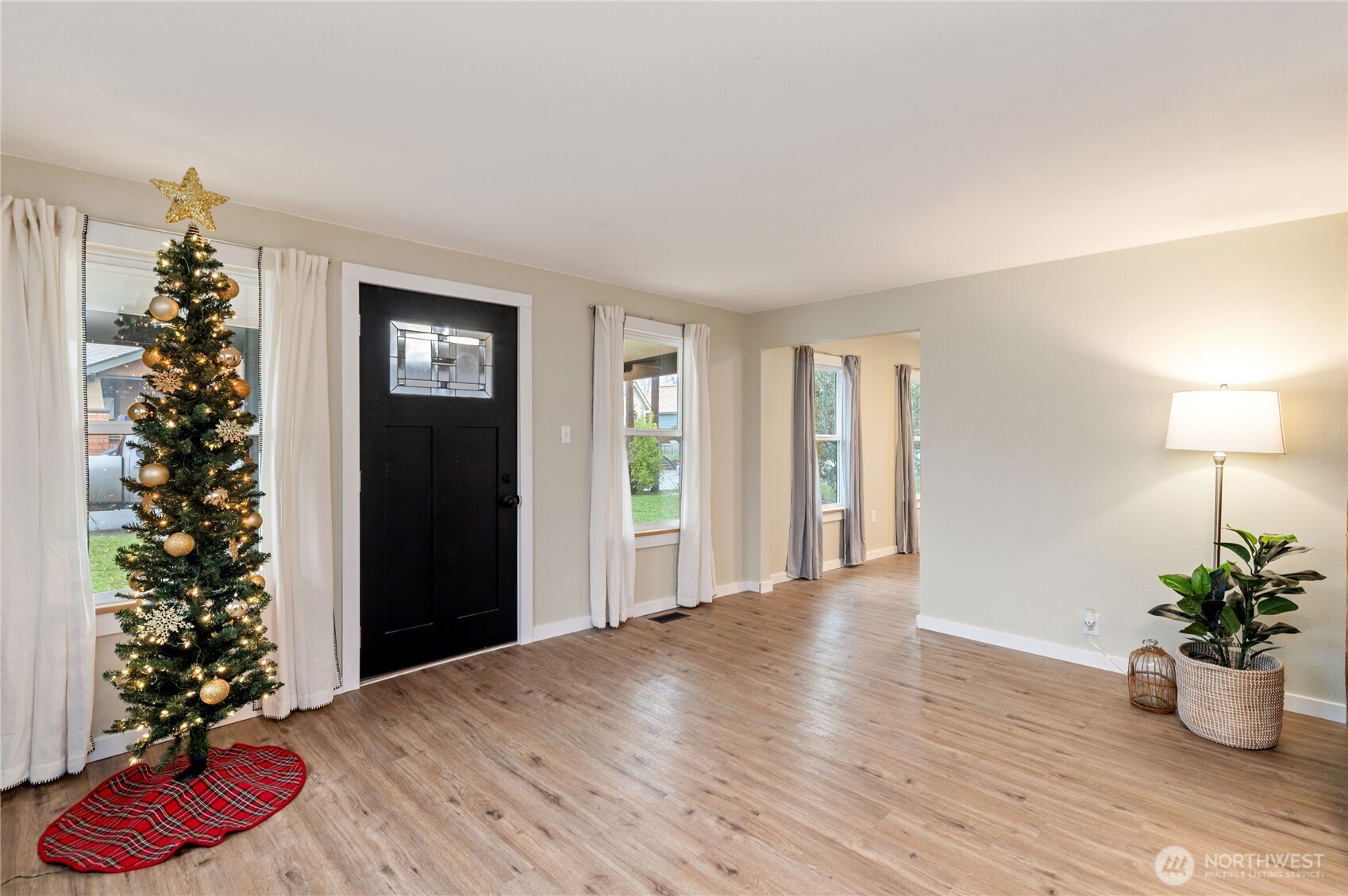 2013 8th Street Bremerton, WA 98337 - Photo 8 of 22 a view of a room with wooden floor and potted plant