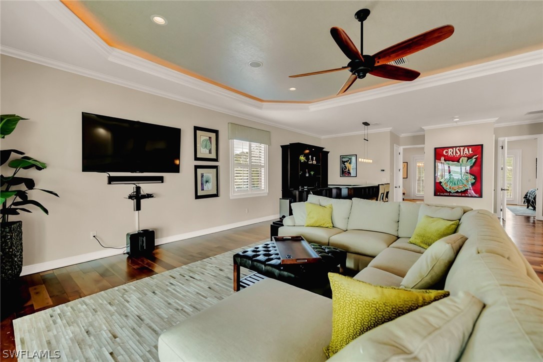 8347 Midnight Pass Road Sarasota, FL 34242 - Photo 13 of 34 a living room with furniture and a flat screen tv