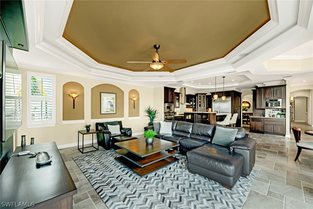 8347 Midnight Pass Road Sarasota, FL 34242 - Photo 15 of 34 a living room with furniture ceiling fan and a rug