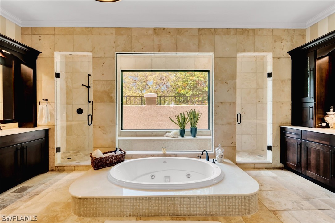 8347 Midnight Pass Road Sarasota, FL 34242 - Photo 17 of 34 a spacious bathroom with a tub sink and mirror