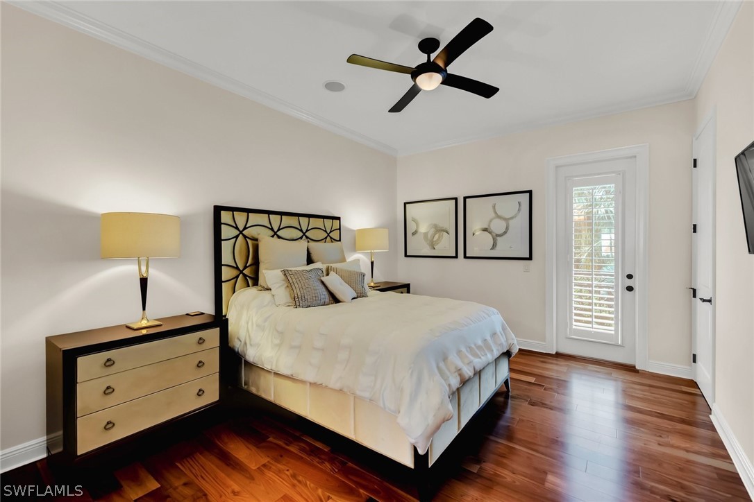 8347 Midnight Pass Road Sarasota, FL 34242 - Photo 18 of 34 a bedroom with a bed lamp and a closet