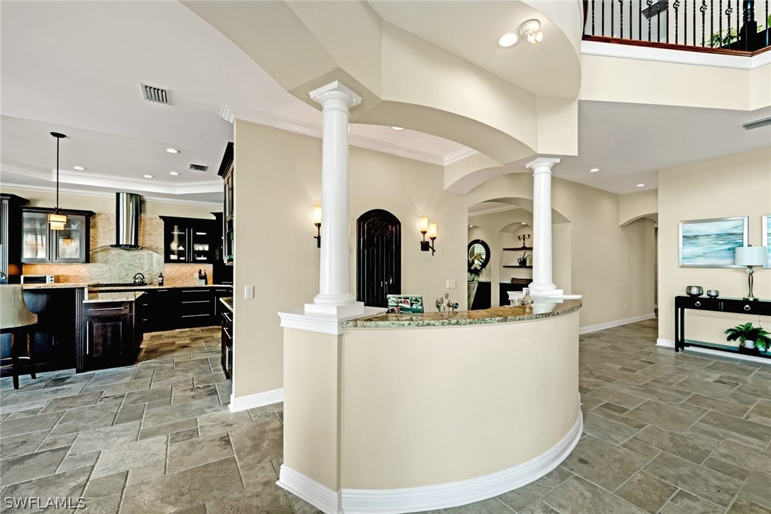 8347 Midnight Pass Road Sarasota, FL 34242 - Photo 23 of 34 a large kitchen with stainless steel appliances kitchen island a large counter top a stove a chimney a sink and a refrigerator