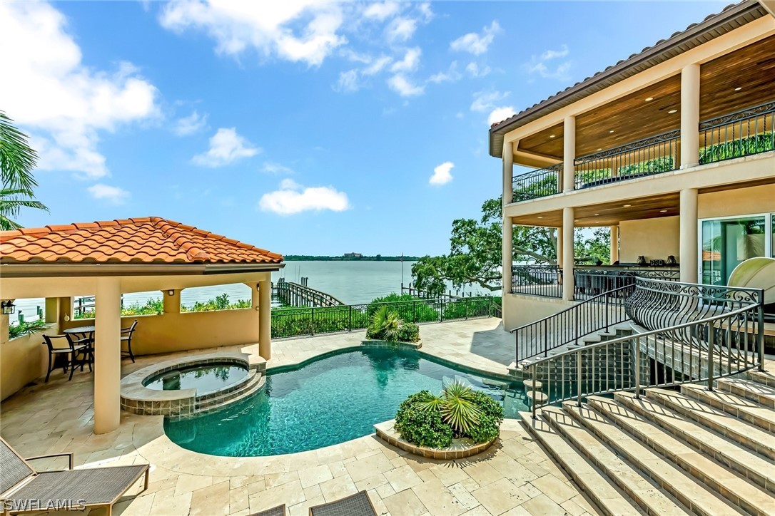 8347 Midnight Pass Road Sarasota, FL 34242 - Photo 29 of 34 a view of a patio with couches table and chairs and potted plants