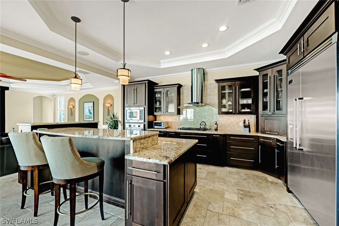 8347 Midnight Pass Road Sarasota, FL 34242 - Photo 4 of 34 a kitchen with stainless steel appliances granite countertop a sink and a refrigerator