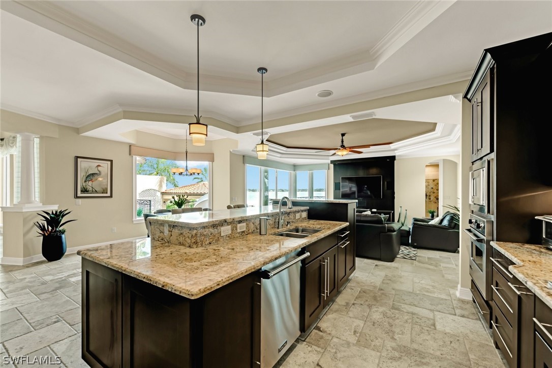 8347 Midnight Pass Road Sarasota, FL 34242 - Photo 5 of 34 a kitchen with granite countertop a stove a sink a dining table and chairs
