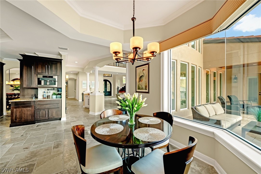 8347 Midnight Pass Road Sarasota, FL 34242 - Photo 7 of 34 a dining room with furniture a chandelier and wooden floor