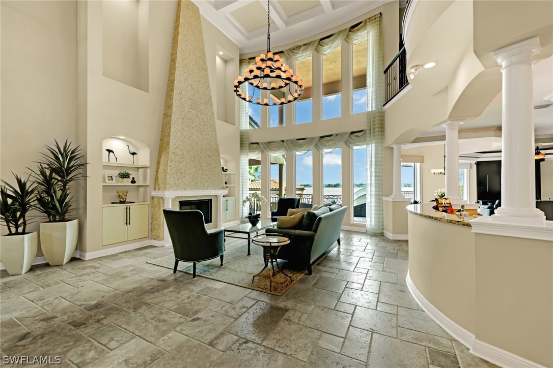 8347 Midnight Pass Road Sarasota, FL 34242 - Photo 10 of 34 a living room with furniture a fireplace and a chandelier