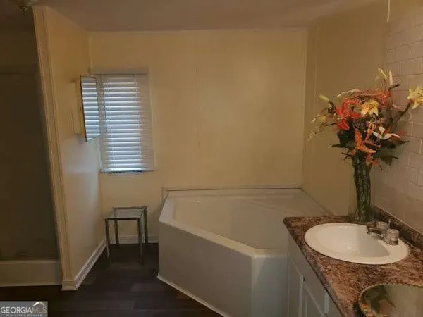 a bath room with a sink and a mirror