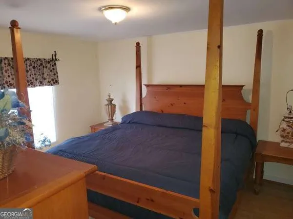 a bedroom with a bed and a mirror