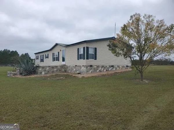 a front view of house with yard and trees