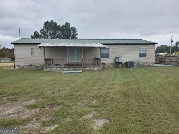 a view of a house with a yard and sitting area