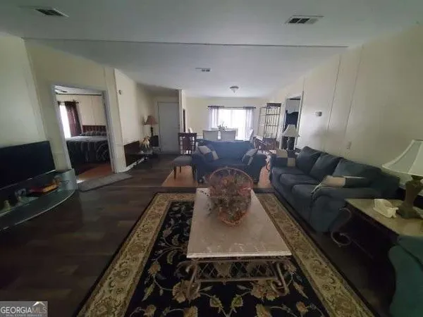 a living room with furniture rug and a flat screen tv
