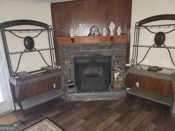 a living room with a fireplace and a wooden floor