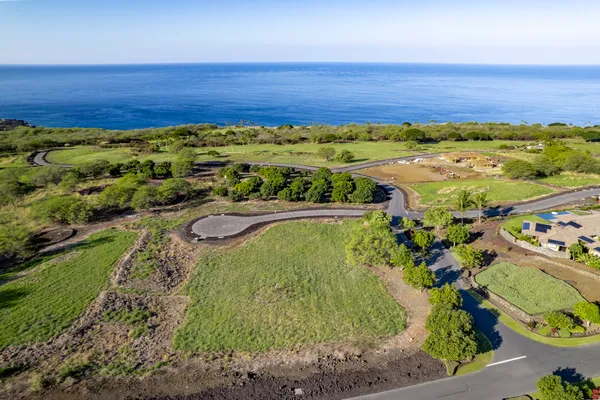 a view of a field with an ocean