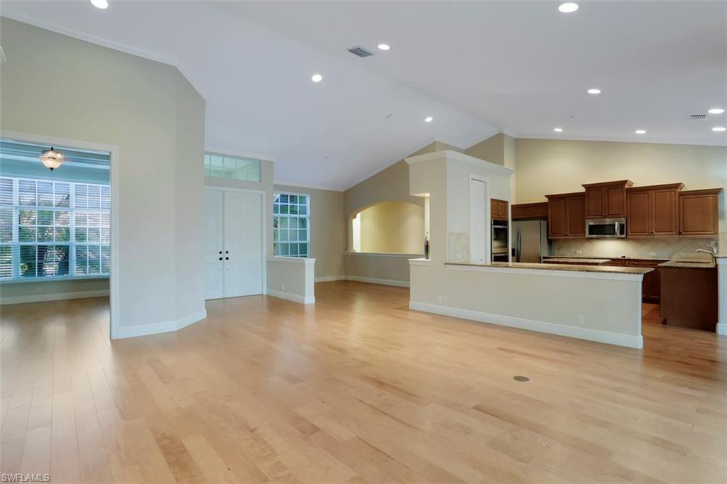 7856 Classics Drive Naples, FL 34113 - Photo 16 of 25 a view of kitchen with cabinets and wooden floor