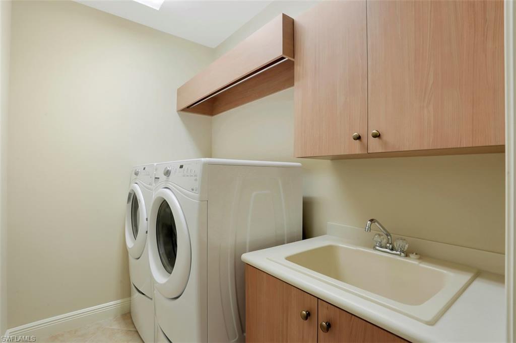 7856 Classics Drive Naples, FL 34113 - Photo 19 of 25 a utility room with dryer and washer