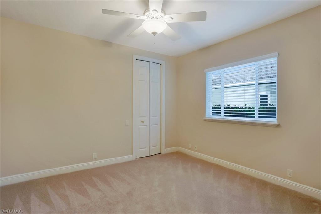 7856 Classics Drive Naples, FL 34113 - Photo 20 of 25 an empty room with windows and fan