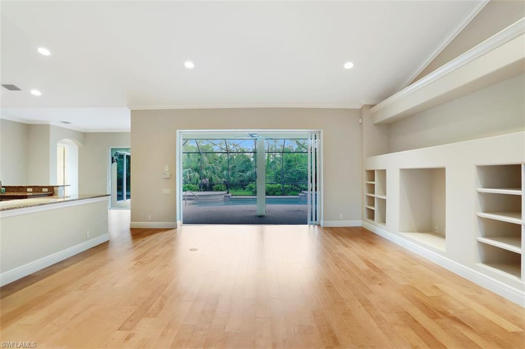 7856 Classics Drive Naples, FL 34113 - Photo 2 of 25 a view of a big room with wooden floor and windows