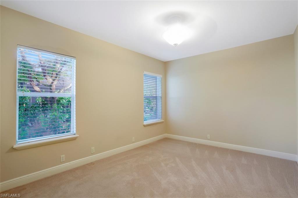 7856 Classics Drive Naples, FL 34113 - Photo 21 of 25 en empty room with windows