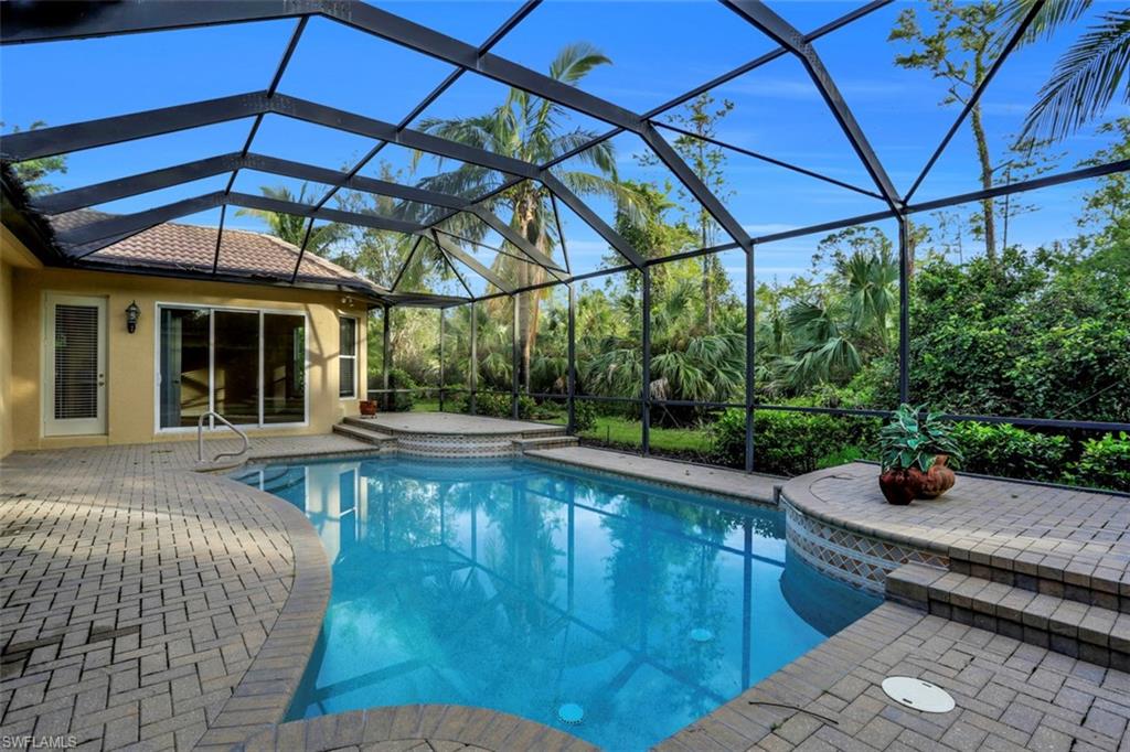 7856 Classics Drive Naples, FL 34113 - Photo 23 of 25 a view of a swimming pool with a patio