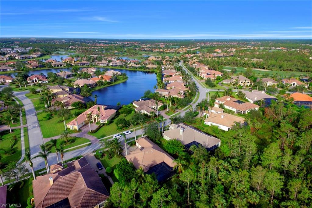 7856 Classics Drive Naples, FL 34113 - Photo 25 of 25 an aerial view of residential houses with outdoor space and trees