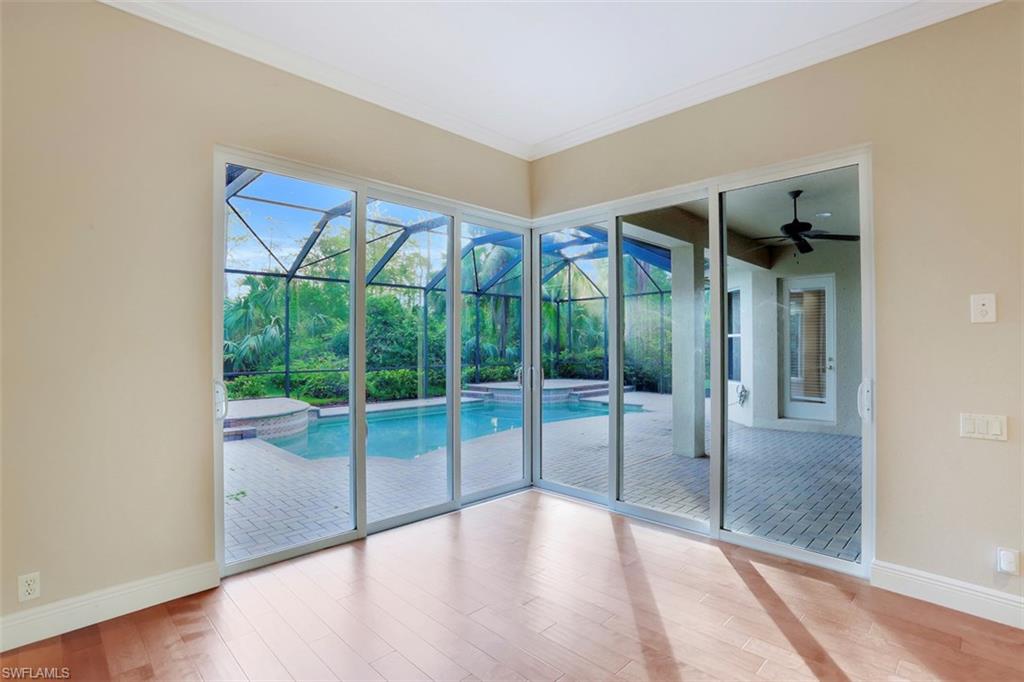 7856 Classics Drive Naples, FL 34113 - Photo 9 of 25 a view of an empty room with glass door