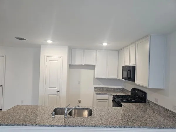 a room with a couch and a stove top oven