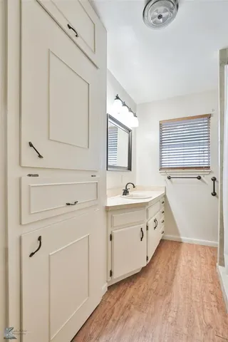a spacious bathroom with a tub sink and mirror